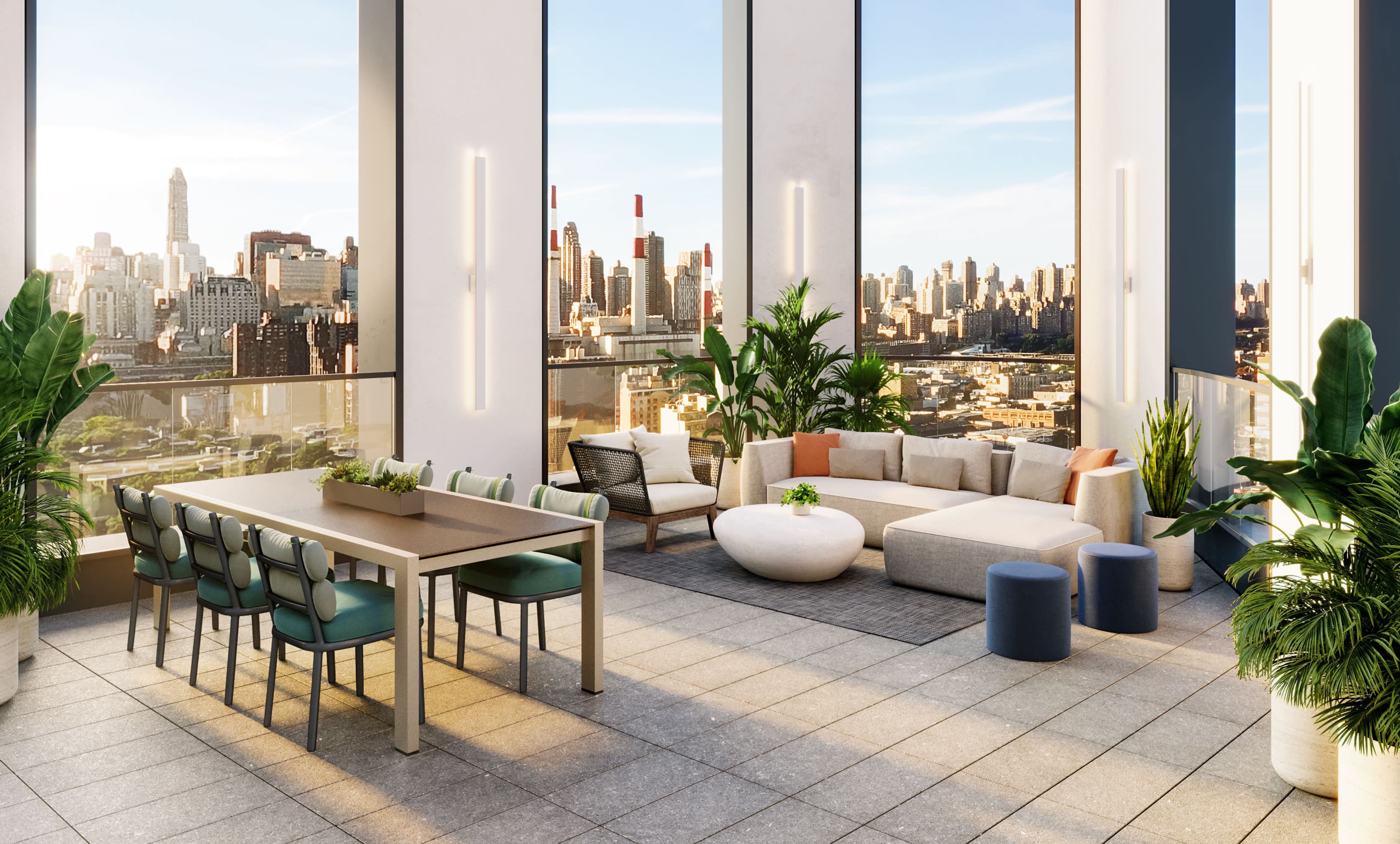 Roof deck amenity at NOVA Long Island City condos. Dining table next to outdoor sectional couch and armchair.